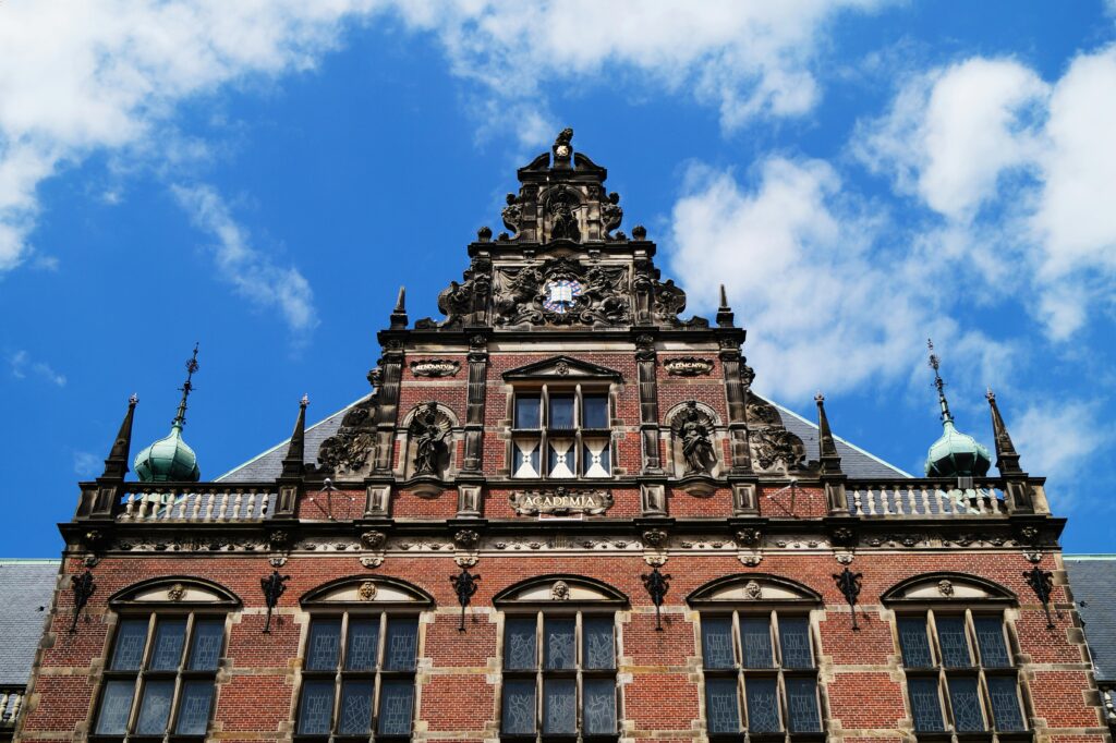 A stunning view of the historic university building facade under a clear blue sky in Groningen.