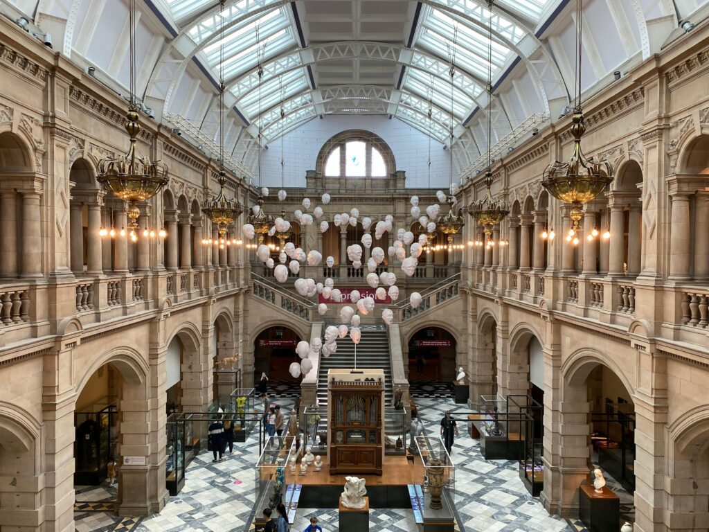 Interior view of Kelvingrove Art Gallery in Glasgow, featuring grand architecture and ceiling lighting.