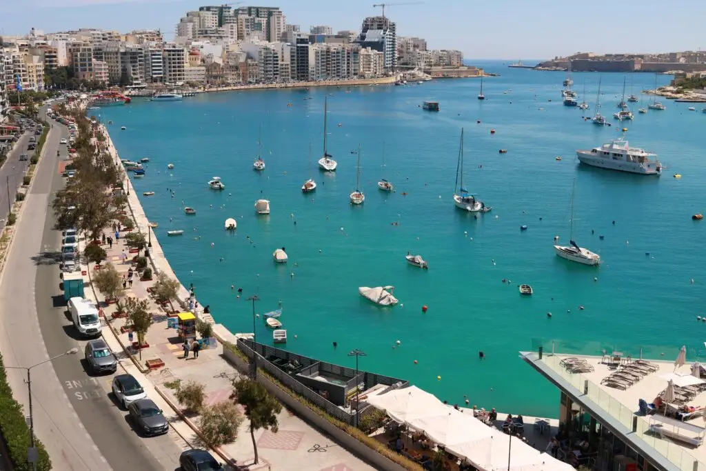Breathtaking aerial view of Sliema Harbor with boats and a lively coastline in Malta.