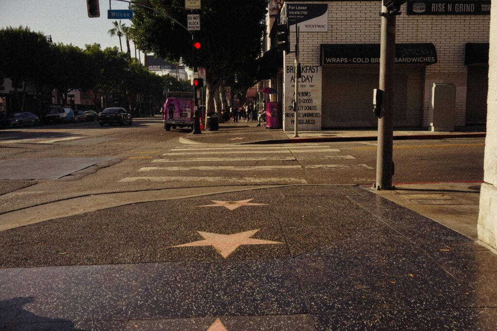 View of Hollywood Boulevard with Walk of Fame stars and city hustle in daylight.