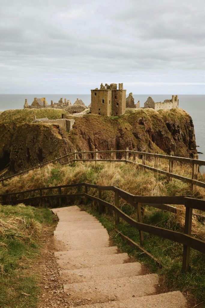 Explore the majestic ruins of Dunnottar Castle perched on a cliff in Scotland.