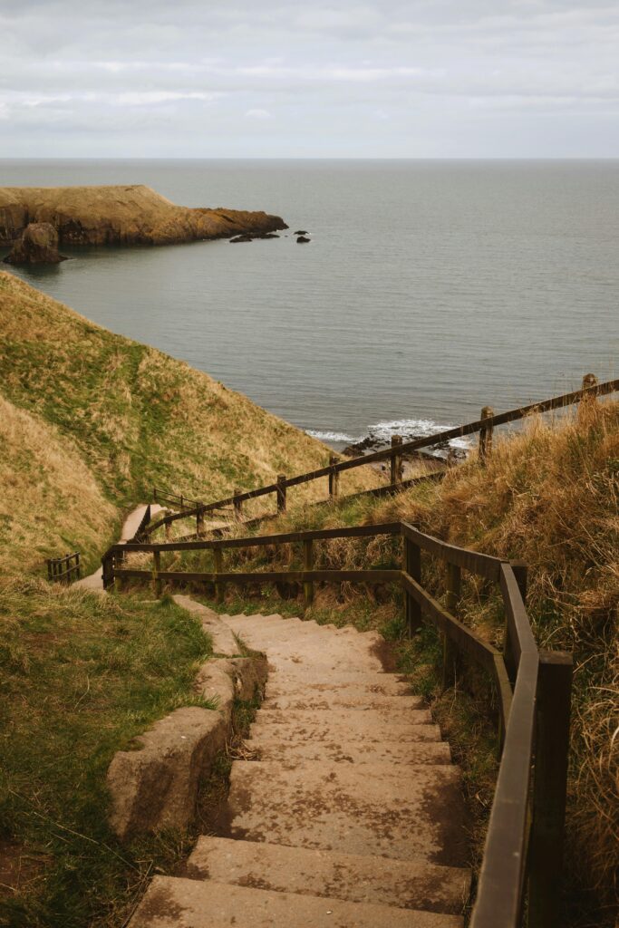 Explore the breathtaking coastal views on a pathway in Aberdeen, Scotland.