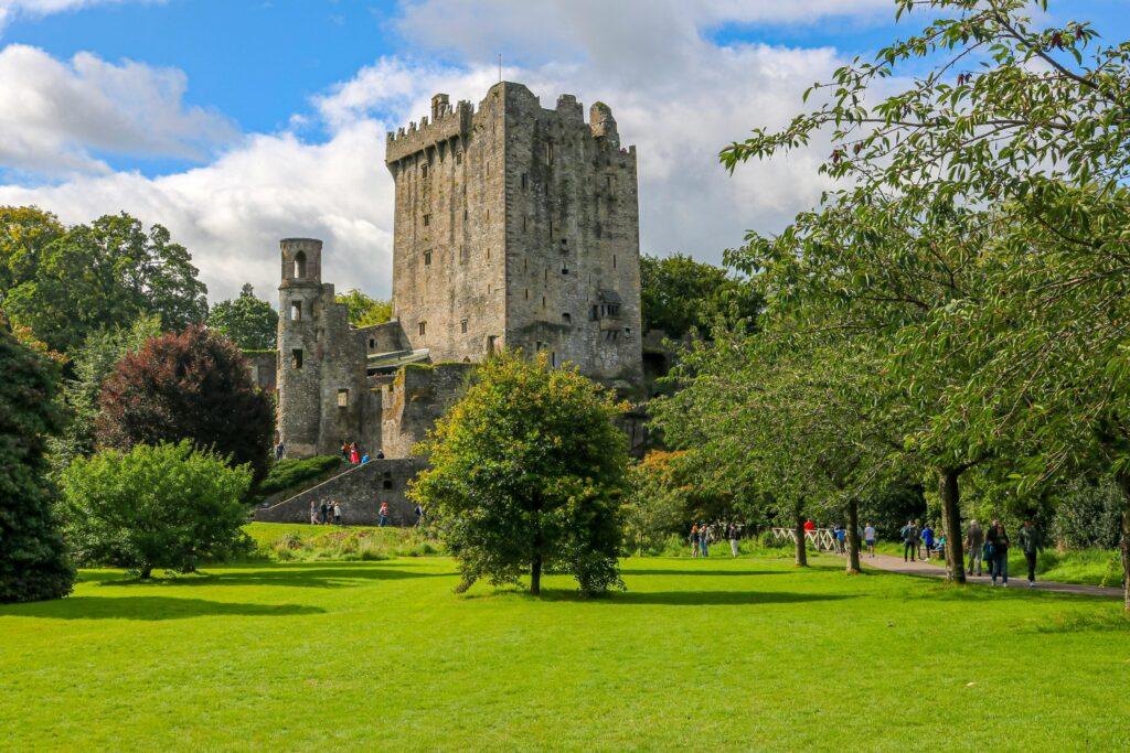 Scenic view of Blarney Castle surrounded by lush greenery in Blarney, Ireland.